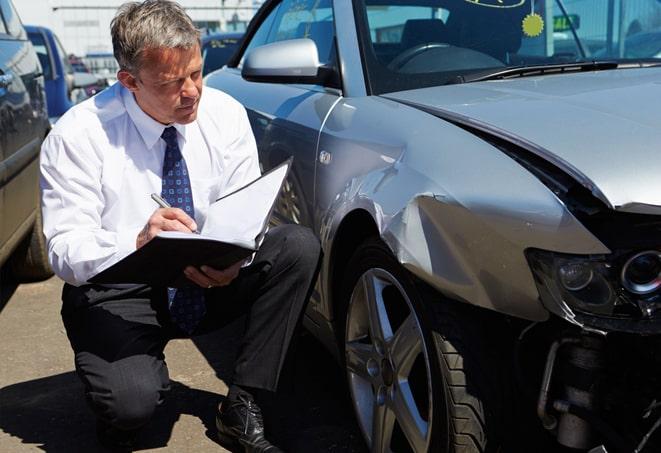 an auto insurance claim being filed online with a laptop